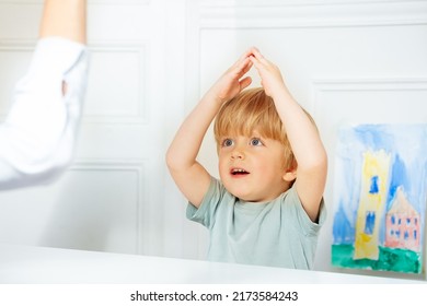 Smart Blond Boy In Development Play Finger Game In Class With Therapist Setting Example Sitting By The Desk