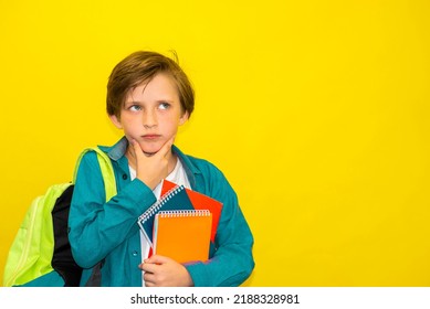 Smart Boy With A Backpack And Notebooks Thinks. No Yellow Background