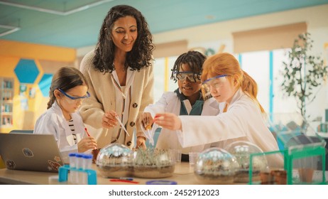 Smart Boys and Talented Girls Experimenting with Growing Crops and Testing Different Nutrition Additives. Young Teacher Helping Elementary School Pupils with Biology and Chemistry Classes - Powered by Shutterstock