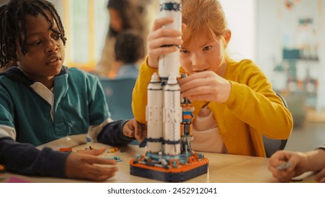 Smart Boys and Talented Girls Making a Model of a Modern Multiplanetary Space Rocket. Young Gifted Future Engineers Studying Science, Engineering, Space and Technology in Primary STEM School - Powered by Shutterstock