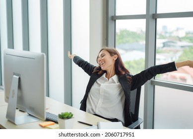 Smart Business Woman In Formal Suit Outfit Sitting And Stretch Relax In Front Of Computer With Happy And Smile In Modern Office Workplace.