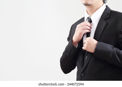 Smart Businessman adjust his tie before start with job 