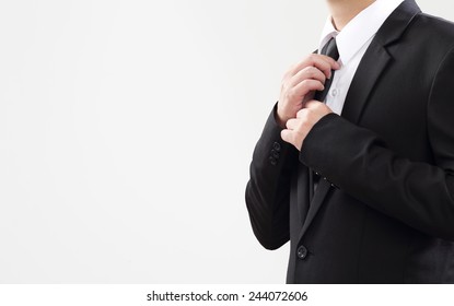 Smart Businessman adjust his tie before start with job 