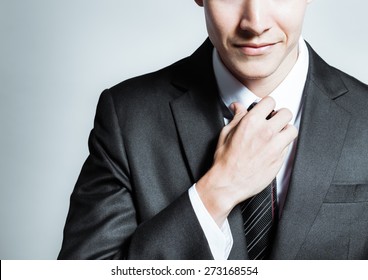Smart businessman fixing his tie.