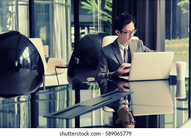 Smart businessman planning new project on his laptop and hold tablet in his hand - Shutterstock ID 589065779