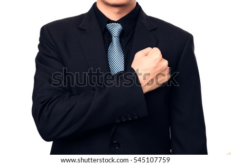 Smart businessman showing a trust by put his fist on a left chest.