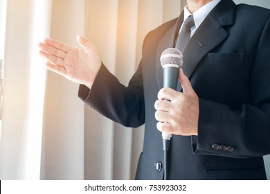 Smart businessman speech and speaking with microphones in seminar room or talking conference hall light with microphones and keynote. Speech is vocalized form of communication humans.