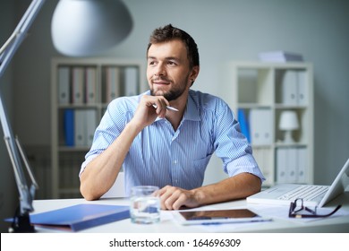 Smart businessman thinking about something in office