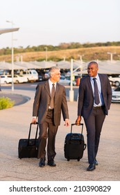 Smart Businessmen Walking In Airport Parking Lot