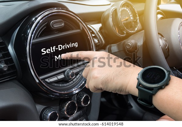 Smart\
car (HUD) concept. Finger pointing to car \'s display screen to\
Self-Driving mode in vehicle. Flare light\
effect