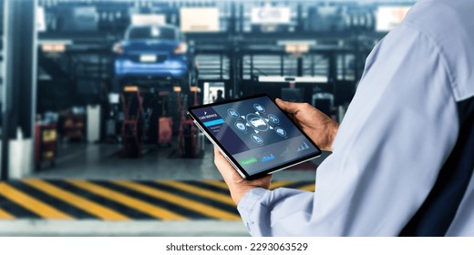 Smart Car Service Diagnostics Software concept.Mechanic using digital tablet Inspecting the Vehicle - Powered by Shutterstock