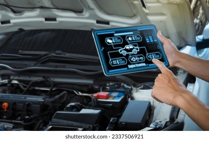 Smart Car Service Diagnostics Software concept.Mechanic using digital tablet Inspecting the Vehicle - Powered by Shutterstock