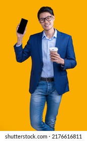 Smart Casual Asian Businessman Wear Glasses Hand Hold Coffee Sup Showing Blank Screen Monitor Smartphone,smiling Asia Man Hand Present Smartphone Black Screen Studio Shot Yellow Background