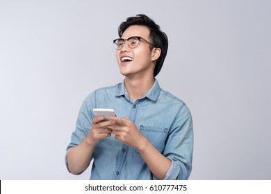 Smart Casual Asian Man Using Smartphone In Studio Background