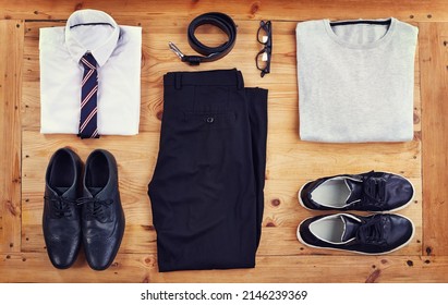 Smart or casual. High angle shot of a smart and a casual outfit laid out on a wooden table.