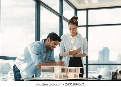 Smart caucasian architect engineer team working together to measure house model. Group of professional interior designer brainstorming and sharing ideas about design building construction. Tracery. - Powered by Shutterstock