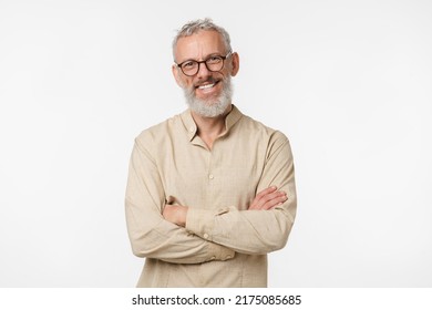 Smart caucasian mature middle-aged freelancer man in beige shirt wearing glasses looking at camera with arms crossed isolated in white background - Shutterstock ID 2175085685