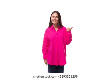 a smart caucasian woman with black straight hair is dressed in a crimson shirt with her index finger pointing at an empty space - Shutterstock ID 2393521259