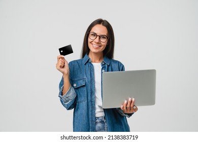 Smart caucasian young woman student freelancer bank client customer using credit card for online payment shopping transactions cashback loan on laptop isolated in white background - Shutterstock ID 2138383719
