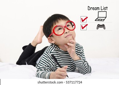 Smart Child Lying On Bed  Writing And Thinking Dream List