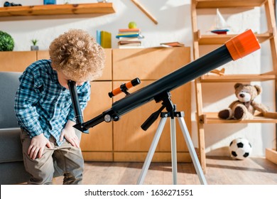 Smart Child In Plaid Shirt Looking Through Telescope