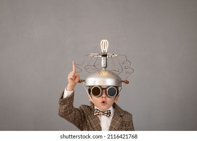 Smart child pretend to be businessman. Funny kid wearing helmet with lightbulb. Education, start up and business idea concept
