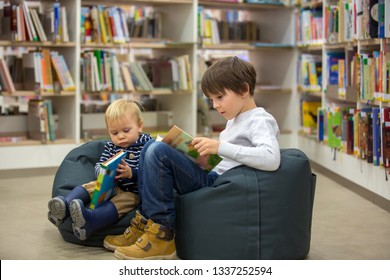 Smart Children, Boy Brothers, Toddler And School Kid, Educating Themselves In A Library, Reading Books And Looking At Pictures