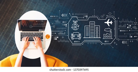 Smart city concept with person using a laptop on a white table - Shutterstock ID 1370397695