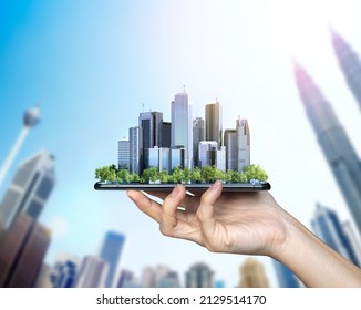 Smart city, hand and smartphone. Kuala Lumpur building background - Powered by Shutterstock