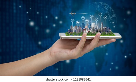 Smart city model on smartphone in women's hand holding with Abstract Blue Technology Background and world map. Binary Computer Code.