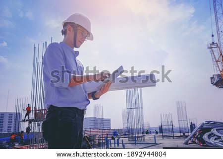Smart civil architect engineer inspecting and working outdoors structure building site with blueprints. engineering and architecture concept.	