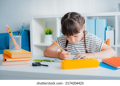 Smart concentrated small 7s years Caucasian girl child sit desk home study distant do homework with textbooks. Pensive little kid handwrite learn preparing school task assignment. Education concept. - Shutterstock ID 2174204425