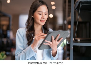 Smart Confidence Asian Female Startup Entrepreneur Small Business Owner Businesswoman Wear Smart Casual Cloth Smile Hand Use Tablet Woking Inventory Checking In Showroom Office Daytime Background