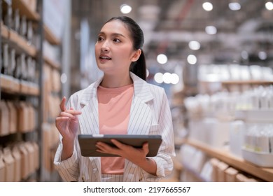 smart confidence asian female startup entrepreneur small business owner businesswoman wear smart casual cloth smile hand use tablet woking inventory checking in showroom office daytime background - Shutterstock ID 2197665567