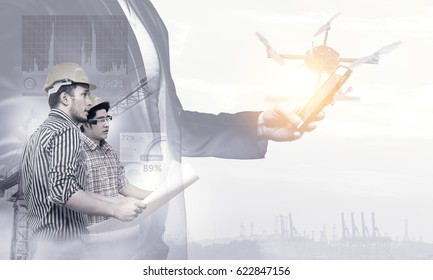 Smart Construction , Augmented Reality In Industry 4.0 Concept. Double Exposure Of Business Hand Suit Using Mobile Phone And Two Engineers Using Ar Glasses With Graphic Popup,drone,crane,harbor.