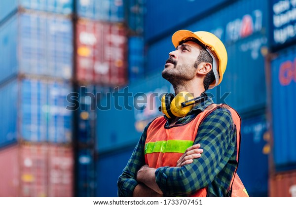 Smart creative\
foreman engineer man control loading containers box from cargo\
freight ship for import export. Logistic, transportation, import\
and export concept with copy\
space.