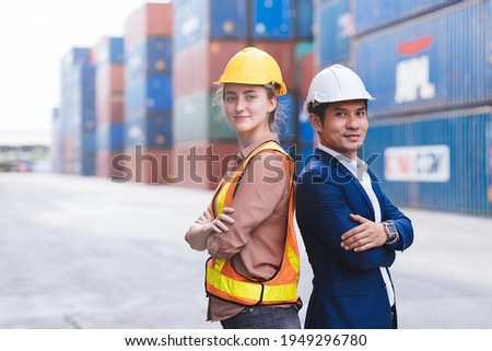 Smart creative foreman and engineer woman wear safety uniform standing and arm crossed containers box background. Logistic, Transportation, import and export concept. Copy space.