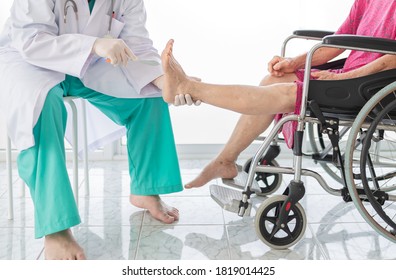 smart doctor holding leg of old stroke patient in hospital, elderly rehabilitation clinic, they training to rehab muscle, foot screening