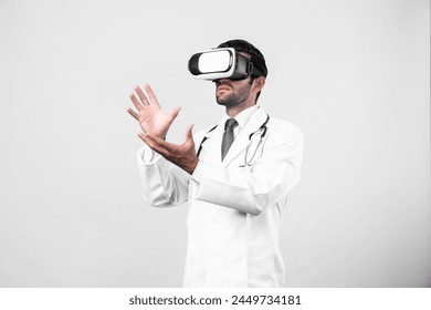 Smart doctor looking VR glass and standing with white background. Caucasian doctor holding and checking medical data while wearing virtual reality world or metaworld. Innovation technology. Deviation. - Powered by Shutterstock