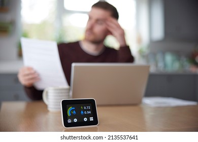 Smart Energy Meter In Kitchen Measuring Electricity And Gas Use With Man Looking At Bills - Shutterstock ID 2135537641