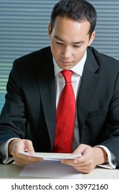 Smart Eurasian Business Man In Formal Attire Working And Browsing With Documents