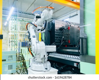 Smart Factory Industry 4.0 Concept From Robotic Arm Machine Tool For Production Line Of Injection Molding Process At Vehicle Industrial Factory.