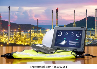 Smart Factory - Rugged Computers Tablet In Front Of Oil Refinery Industry. 