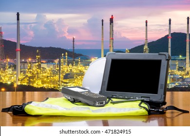 Smart Factory - Rugged Computers Tablet In Front Of Oil Refinery Industry. 