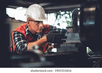 Smart factory worker or engineer do machine job in a manufacturing workshop . Industry and engineering concept .