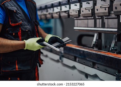 A smart factory worker or engineer makes machines in a production workshop. The concept of industry and engineering. Selective focus