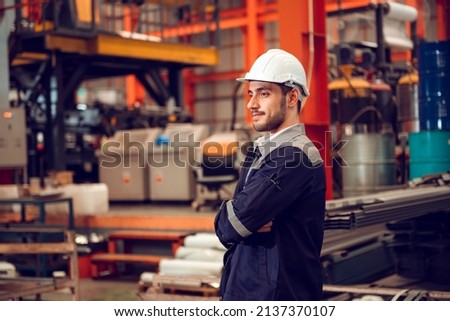 Smart factory worker engineering manager working at industrial worksite , wearing hard hat for safety.