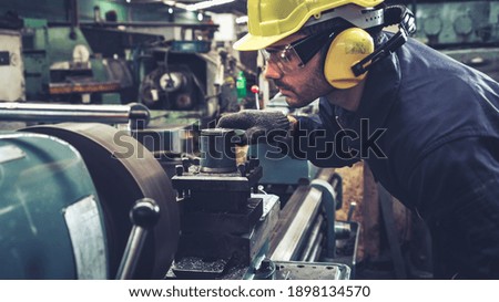 Smart factory worker using machine in factory workshop . Industry and engineering concept.