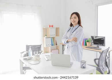 smart female doctor do work in hospital, she stand up and cross arm, she feeling happy in relax time, she ready to service and treatment patient - Powered by Shutterstock