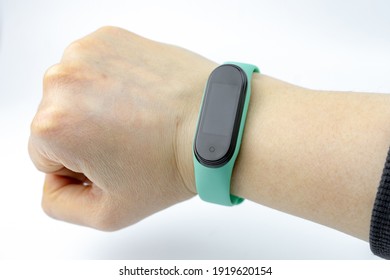 Smart Fitness Bracelet With Colored Strap On Hand Isolated On White Background